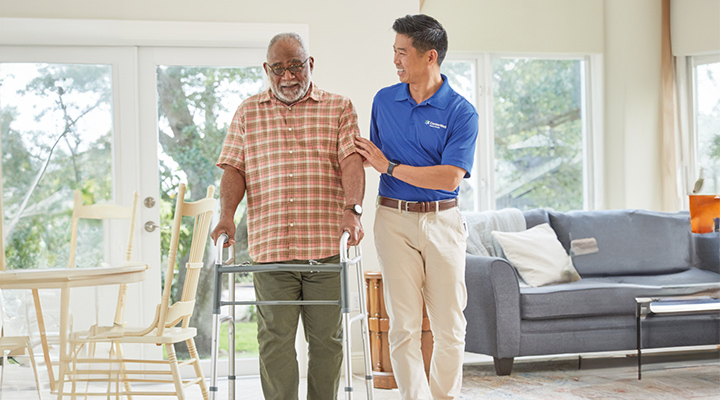 A CenterWell Home Health clinician working with a patient with using a walker