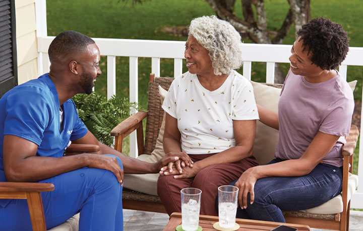 A CenterWell Home Health clinician talking with a patient and a family member